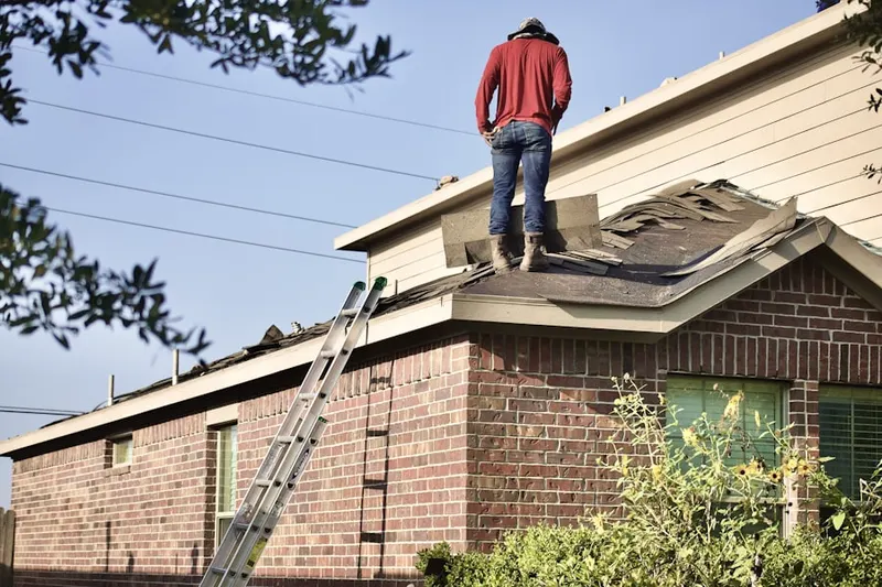 Professional roofer working on a residential roof in Sands Estates